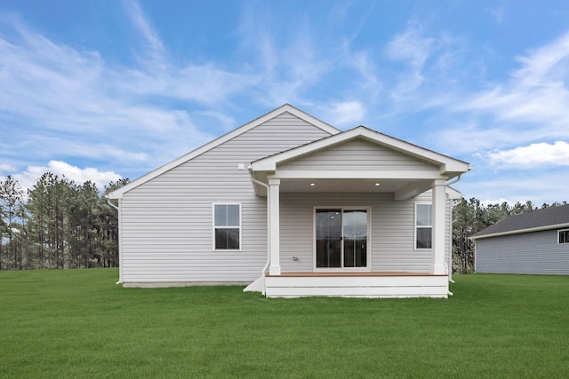 back of property featuring a lawn