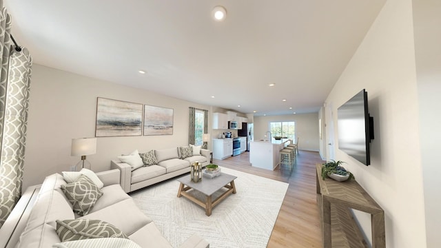 living room featuring light wood-type flooring and recessed lighting