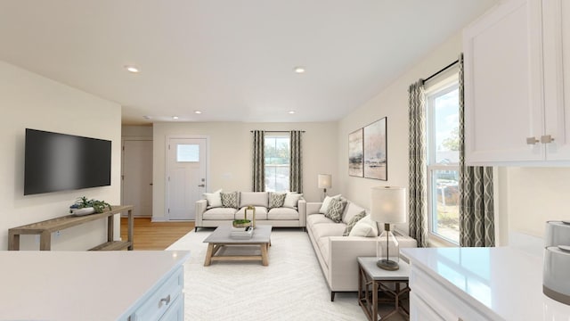 living room with light wood-type flooring and recessed lighting