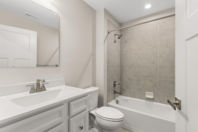 bathroom with visible vents, bathtub / shower combination, vanity, and toilet