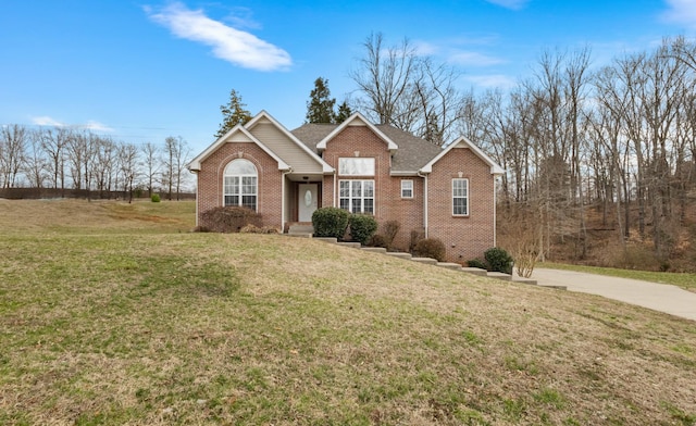 view of front of home with brick siding, a shingled roof, and a front yard