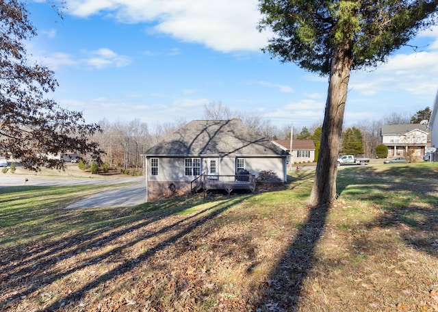 view of front of home featuring a deck and a front lawn