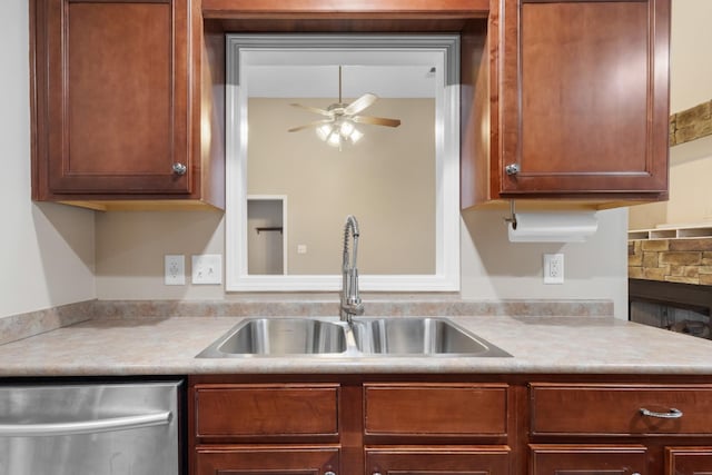 kitchen with light countertops, a sink, dishwasher, and ceiling fan