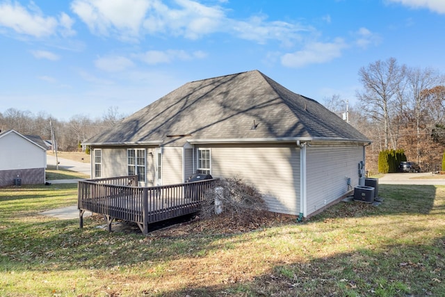 back of house with roof with shingles, a yard, a deck, and central air condition unit