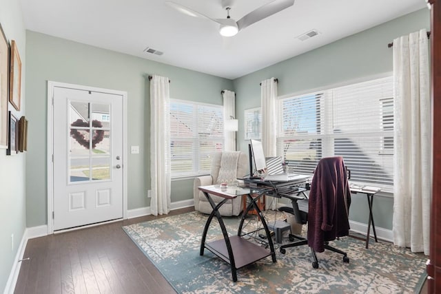 office with baseboards, visible vents, and hardwood / wood-style floors