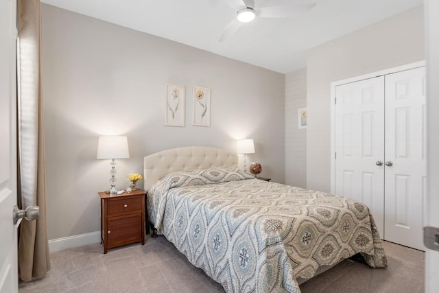 carpeted bedroom with baseboards, a ceiling fan, and a closet