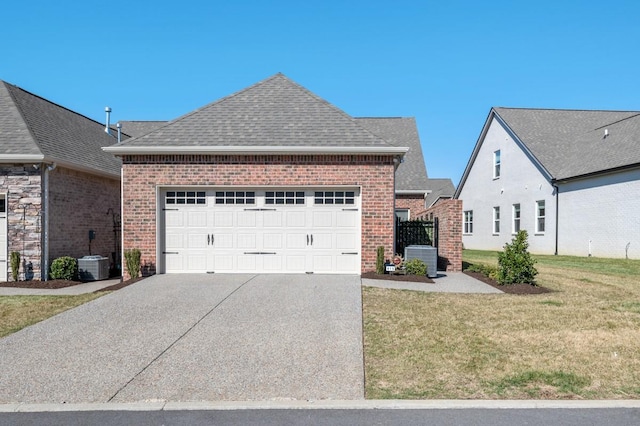 view of front of property with driveway, roof with shingles, central air condition unit, a front yard, and brick siding