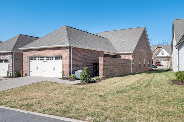 view of side of home with an attached garage, brick siding, a yard, driveway, and roof with shingles