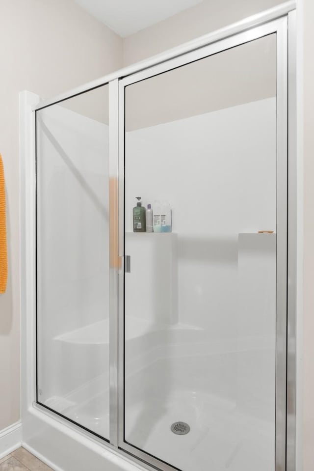 full bathroom with a stall shower and tile patterned floors