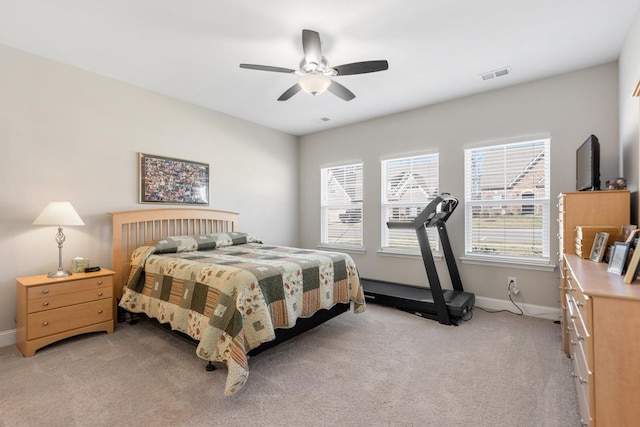 bedroom featuring light carpet, a ceiling fan, visible vents, and baseboards