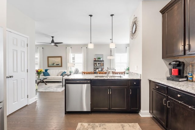 kitchen featuring dark brown cabinetry, a sink, dark wood-style floors, open floor plan, and dishwasher