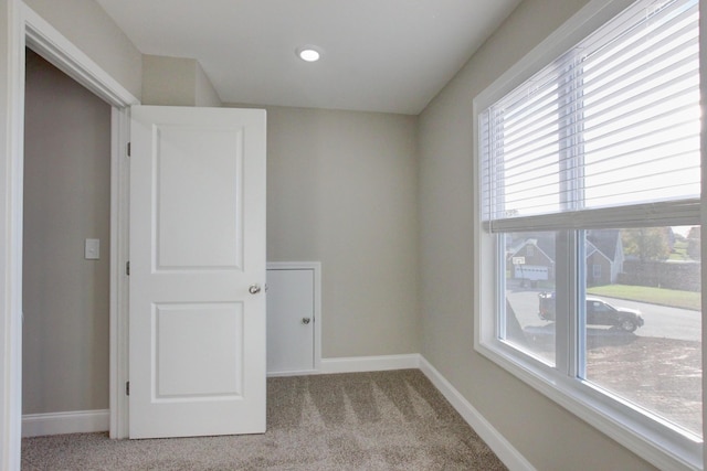 empty room with light carpet and baseboards