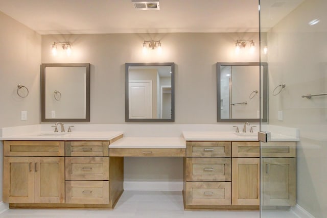 bathroom featuring visible vents, vanity, and baseboards