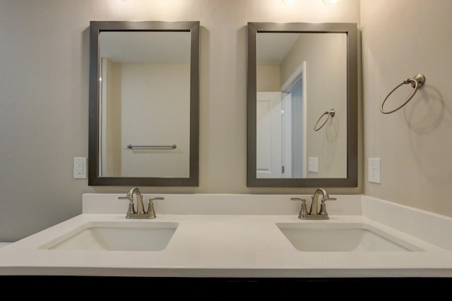 full bathroom featuring double vanity and a sink