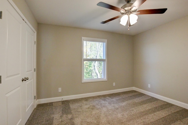 unfurnished bedroom featuring carpet floors, ceiling fan, baseboards, and a closet