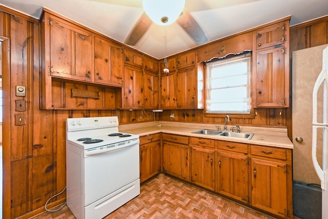 kitchen with brown cabinetry, white range with electric stovetop, light countertops, and a sink