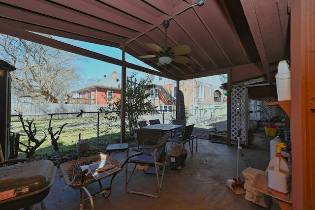 view of patio with outdoor dining area, a fenced backyard, and a ceiling fan