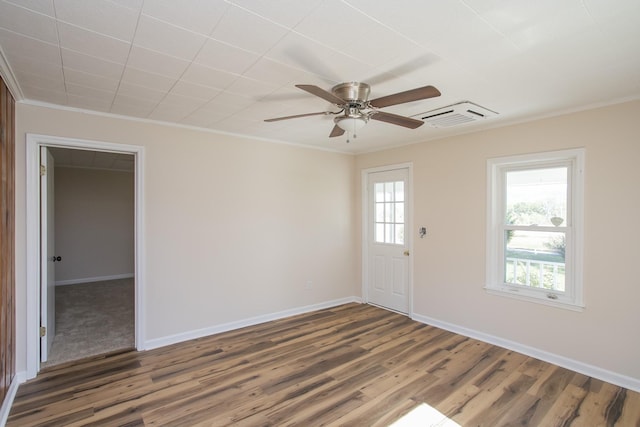 unfurnished room featuring plenty of natural light, wood finished floors, and visible vents