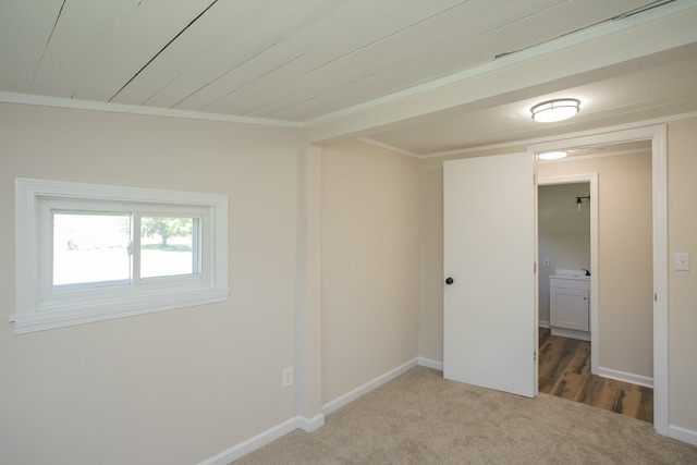 unfurnished room with carpet floors, crown molding, and baseboards