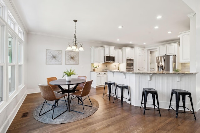 dining room featuring ornamental molding, recessed lighting, dark wood-style flooring, and visible vents