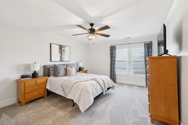 bedroom with light carpet, baseboards, a ceiling fan, and crown molding