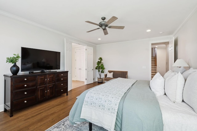 bedroom with crown molding, wood finished floors, and recessed lighting