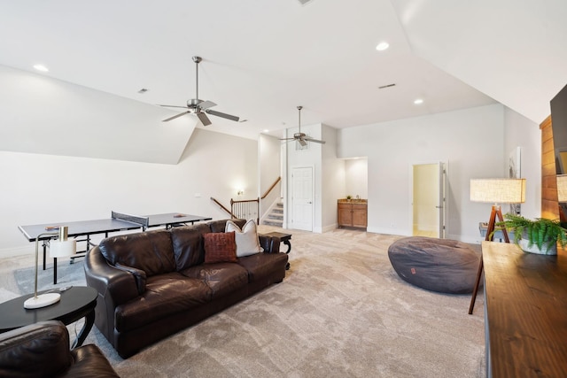 living area featuring stairs, recessed lighting, lofted ceiling, and light colored carpet