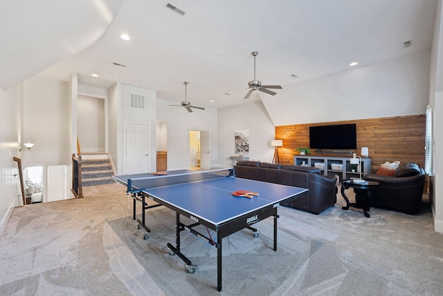 rec room with light carpet, wood walls, and visible vents