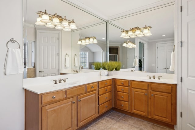 bathroom with double vanity, ornamental molding, and a sink