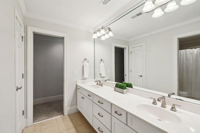 bathroom featuring crown molding, double vanity, visible vents, a sink, and tile patterned floors