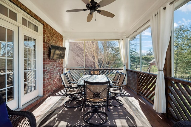 sunroom / solarium featuring ceiling fan