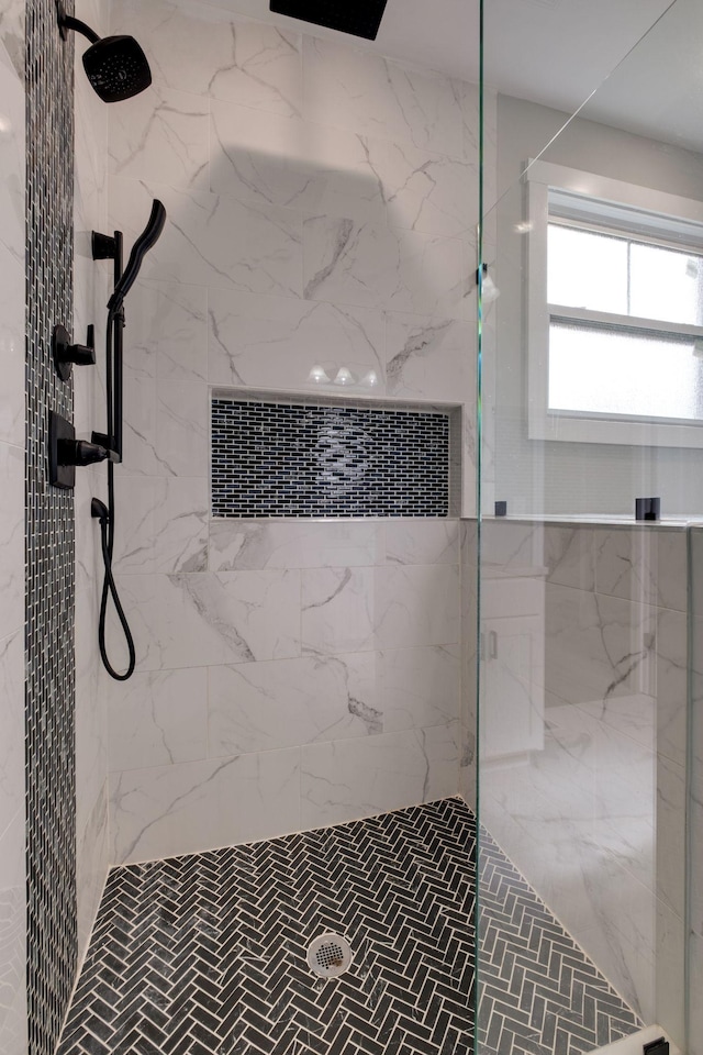 full bath with a marble finish shower