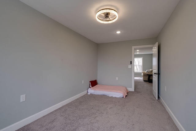 unfurnished bedroom featuring baseboards, carpet flooring, and recessed lighting