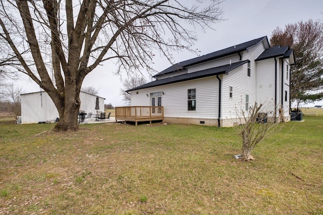 rear view of property featuring crawl space, a shingled roof, a lawn, and a wooden deck