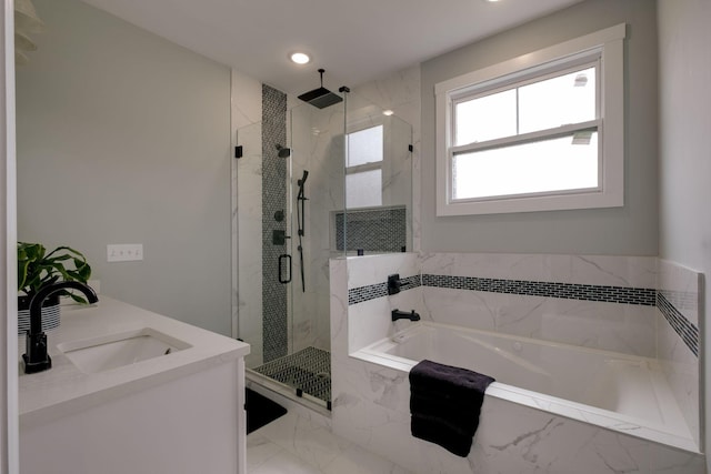 full bath with a garden tub, recessed lighting, a sink, marble finish floor, and a marble finish shower