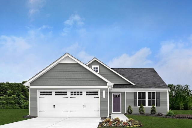 view of front facade featuring driveway, a garage, and a front lawn