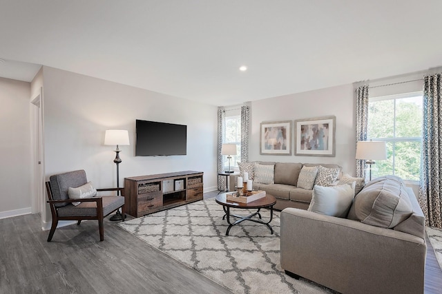 living room with baseboards, wood finished floors, and recessed lighting