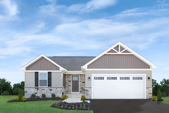 craftsman inspired home featuring aphalt driveway, board and batten siding, an attached garage, and a front lawn