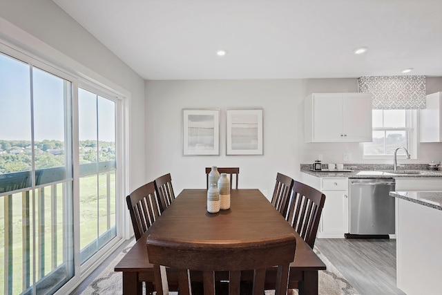 dining room featuring recessed lighting, a wealth of natural light, and light wood-style floors