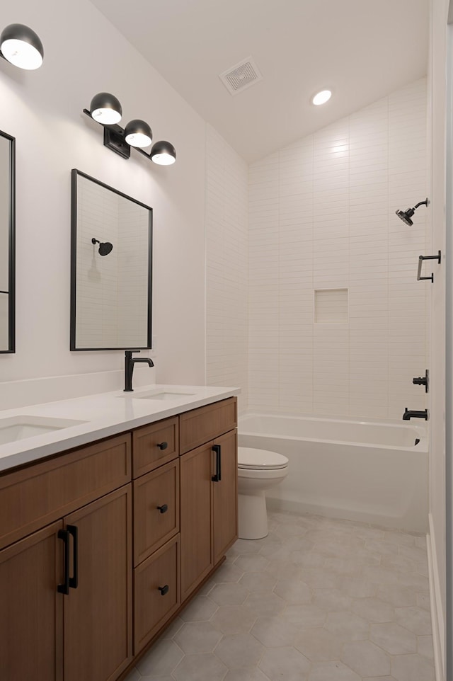 full bathroom with visible vents, a sink, toilet, and double vanity