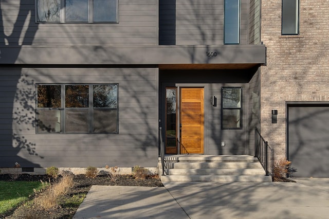 property entrance with crawl space and brick siding