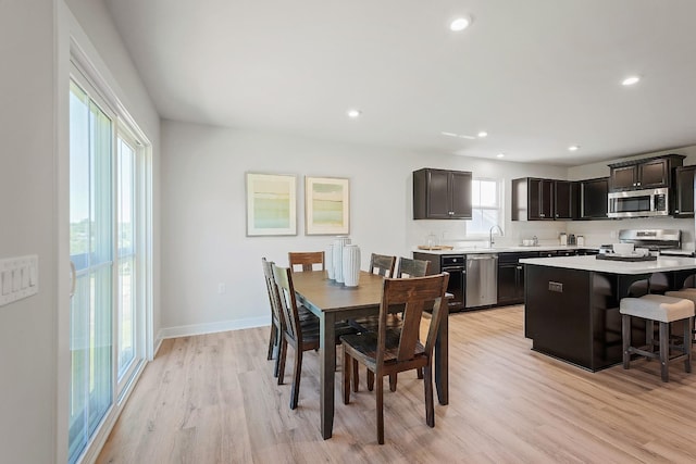 dining area featuring light wood-type flooring, baseboards, and recessed lighting