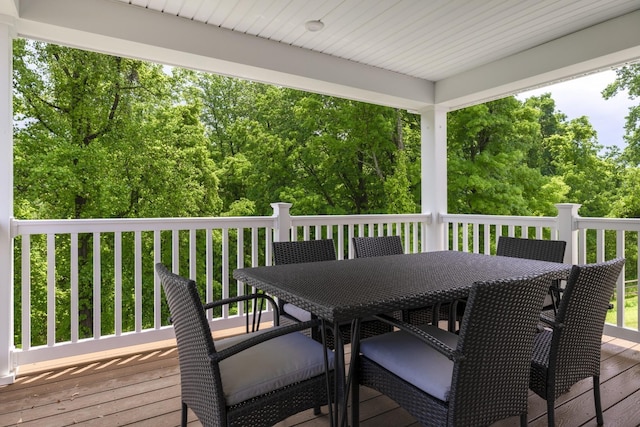 wooden terrace with outdoor dining area