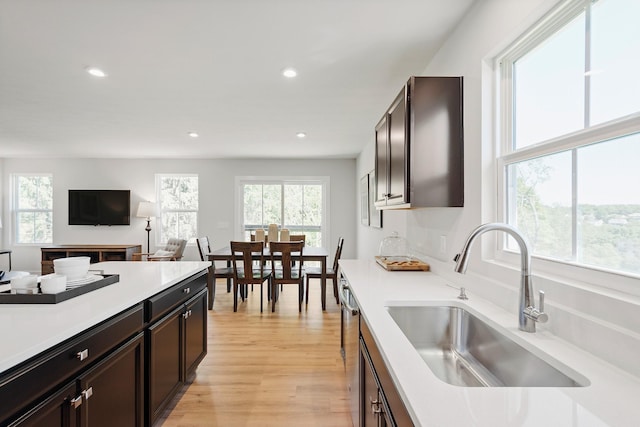 kitchen with light wood-style floors, recessed lighting, light countertops, and a sink