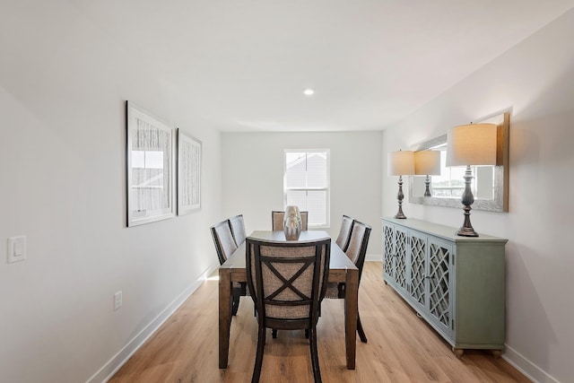 dining room with baseboards and light wood finished floors