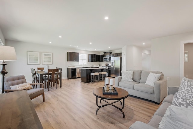 living room with recessed lighting and light wood-style floors