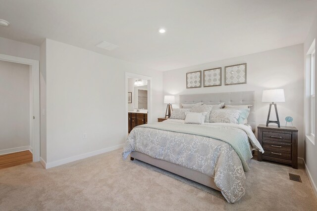 carpeted bedroom featuring recessed lighting, visible vents, connected bathroom, and baseboards