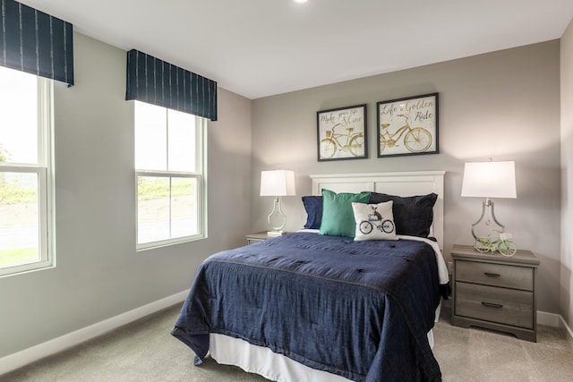 bedroom featuring carpet and baseboards