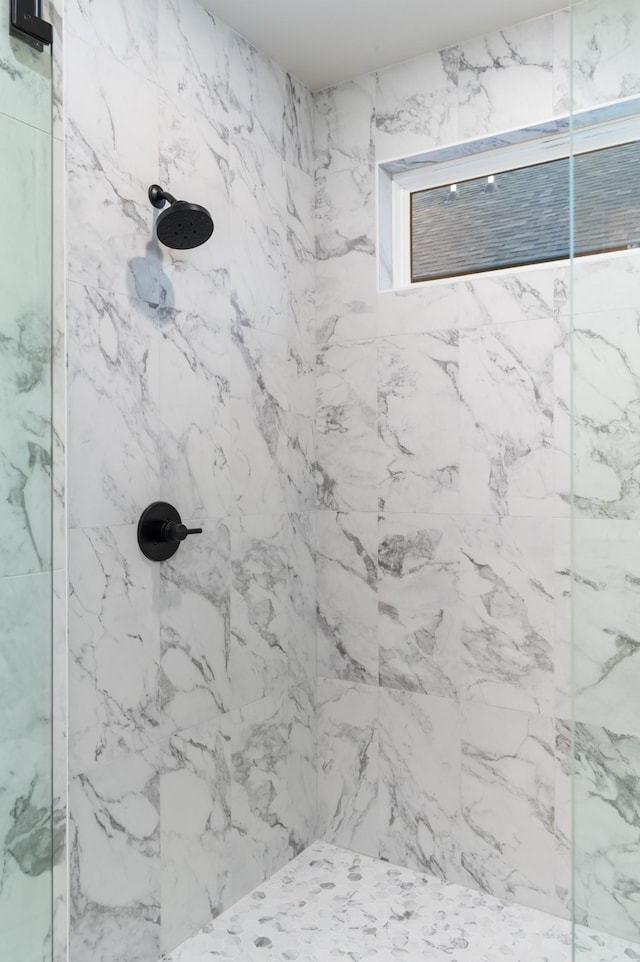 bathroom with a marble finish shower