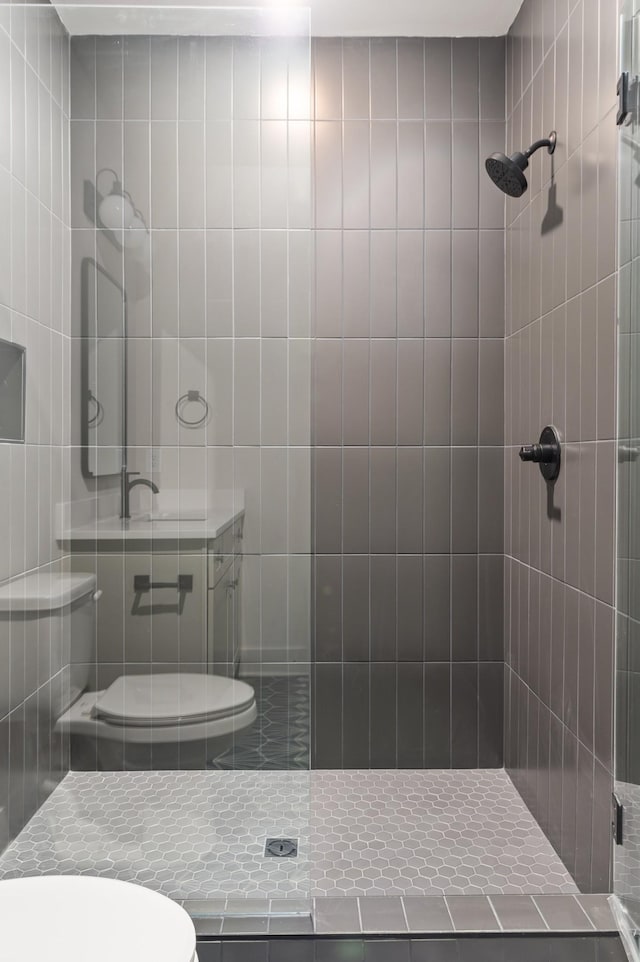 bathroom featuring a stall shower and toilet